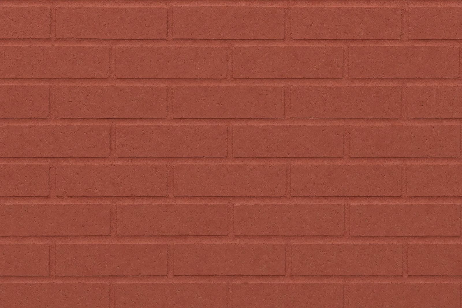 A brick wall covered in one opaque warm red-brown paint layer across both brick and mortar.