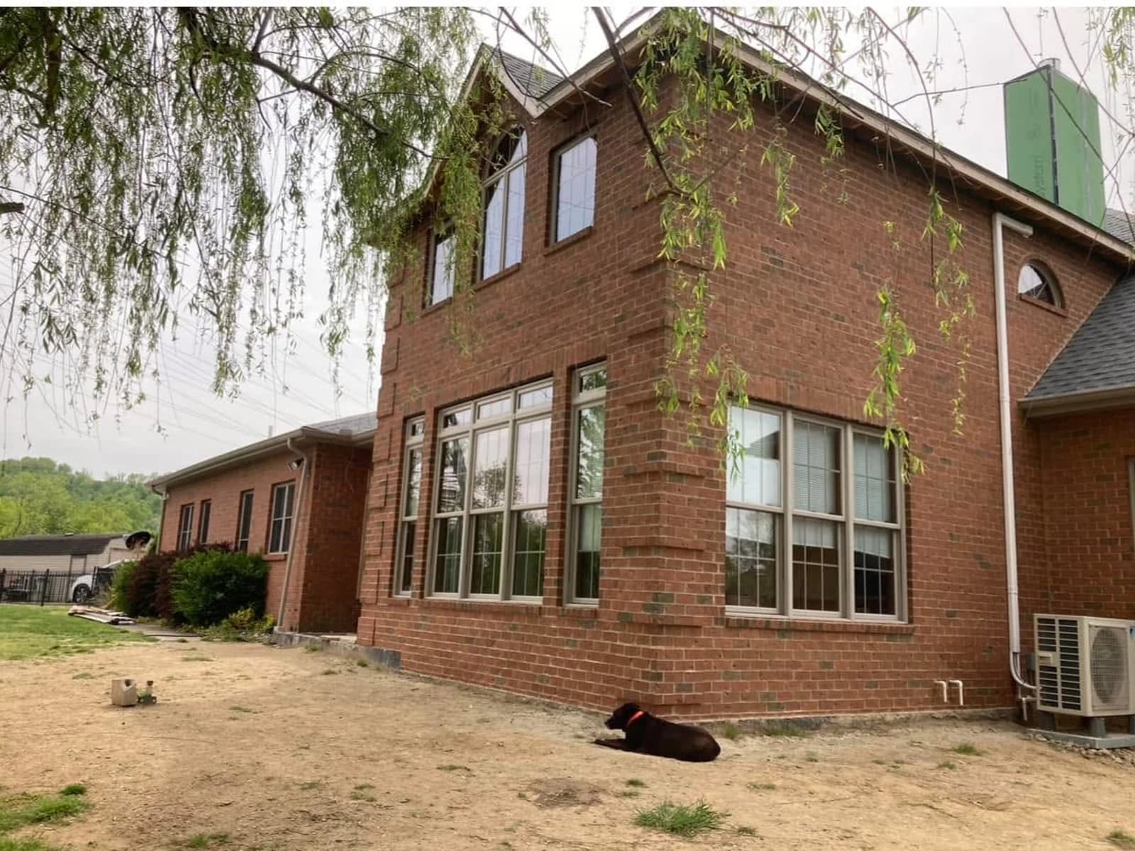 After color correction, the large brick addition relates to the warmer red brick on the rest of the home.