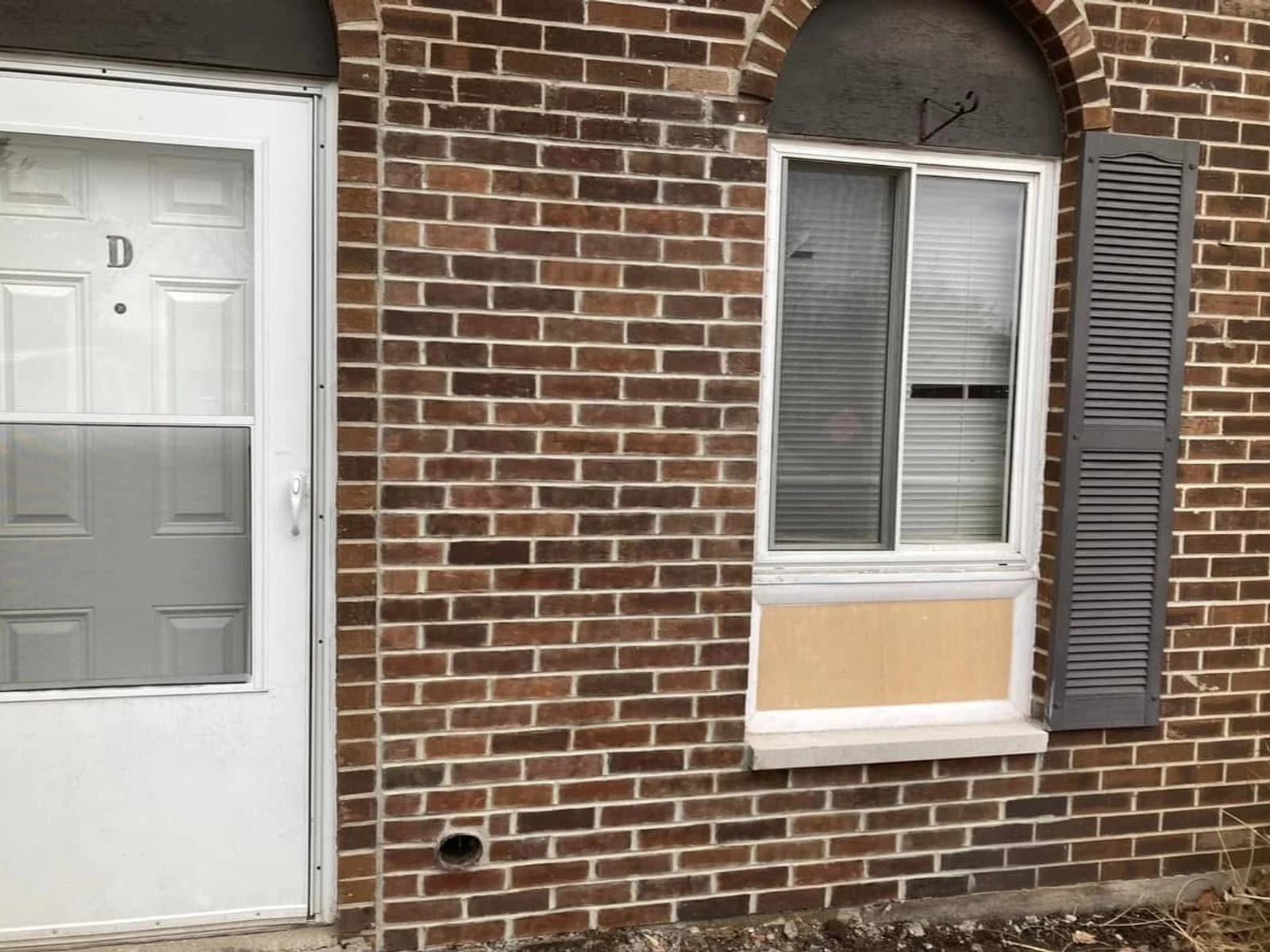 After color correction, the repaired brick area is blended into the darker varied brick wall around it.