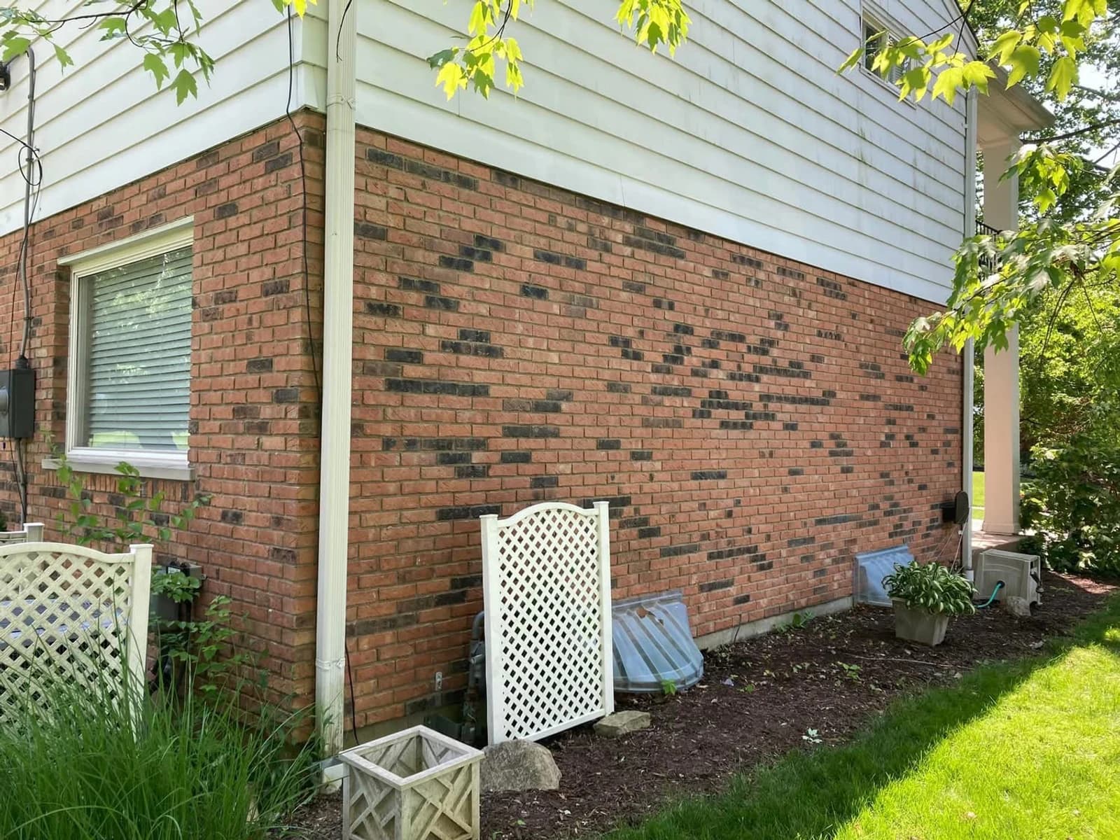 After color correction, the long exterior brick wall has a clearer red appearance while retaining its scattered dark accents.